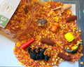 Cozy Fall sensory play kit with fall-coloured rice, pasta, woodland play pieces and bamboo scoop.