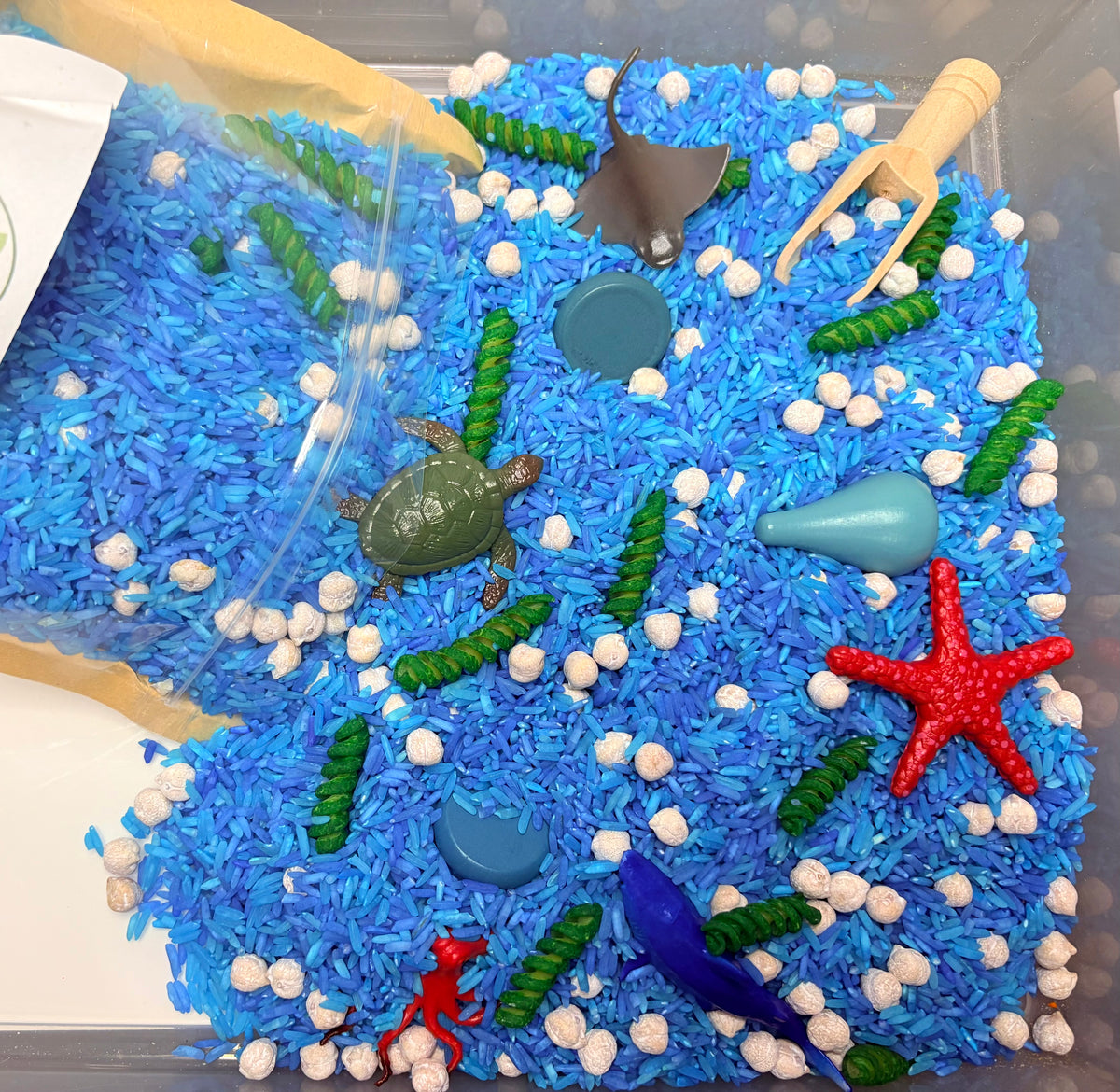 Ocean Dive ready-to-pour sensory play kit with ocean-themed filler and sea animal play pieces.