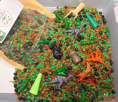 Dino Dig dinosaur sensory play kit with colourful filler, dinosaur figures and a bamboo scoop.